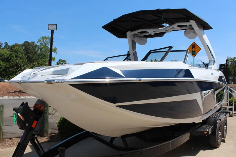 Slide: The Image of 2026 Tigé 22RZX boat on trailer, sleek design, blue and white color scheme. - 7