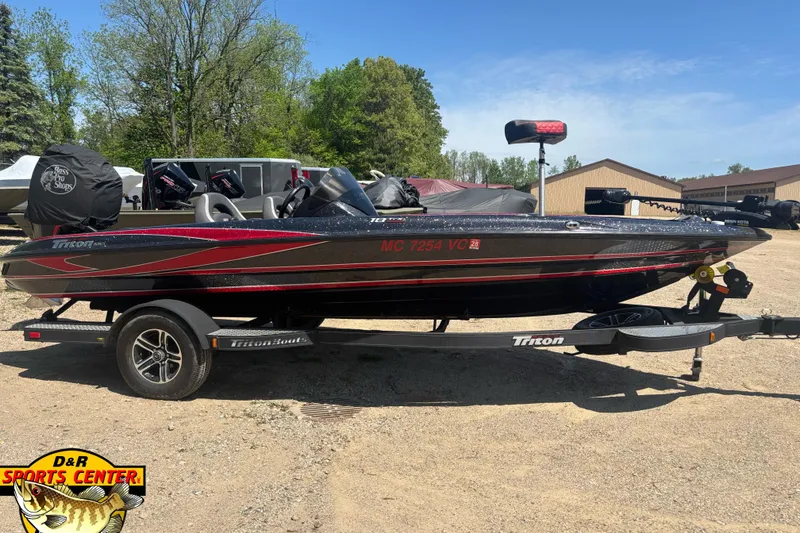 Slide: The Image of 2022 Triton 18 TrX boat on trailer, parked outdoors at D&R Sports Center. - 2