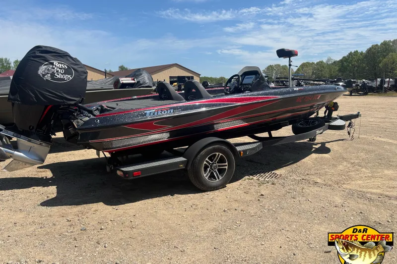 Slide: The Image of 2022 Triton 18 TrX bass boat on trailer, parked outdoors at D&R Sports Center. - 3
