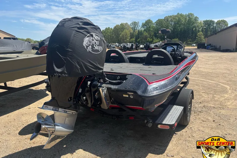 Slide: The Image of 2022 Triton 18 TrX boat with covered motor, parked outdoors at D&R Sports Center. - 4