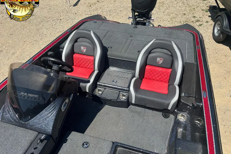 Slide: The Image of 2022 Triton 18 TrX boat interior with red and gray seats, steering console visible. - 5