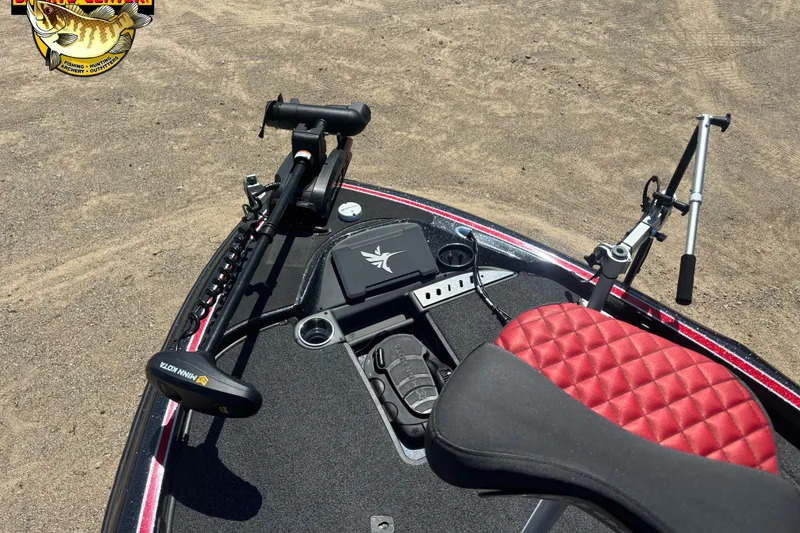 Slide: The Image of 2022 Triton 18 TrX boat deck with red seat and trolling motor. - 7