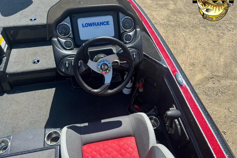 Slide: The Image of 2022 Triton 18 TrX boat cockpit with Lowrance display and red-accented seat. - 9