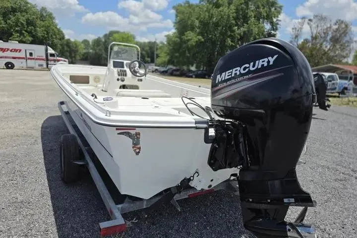 Slide: The Image of 2017 Mako Pro Skiff 21 CC boat with Mercury outboard motor on trailer. - 3