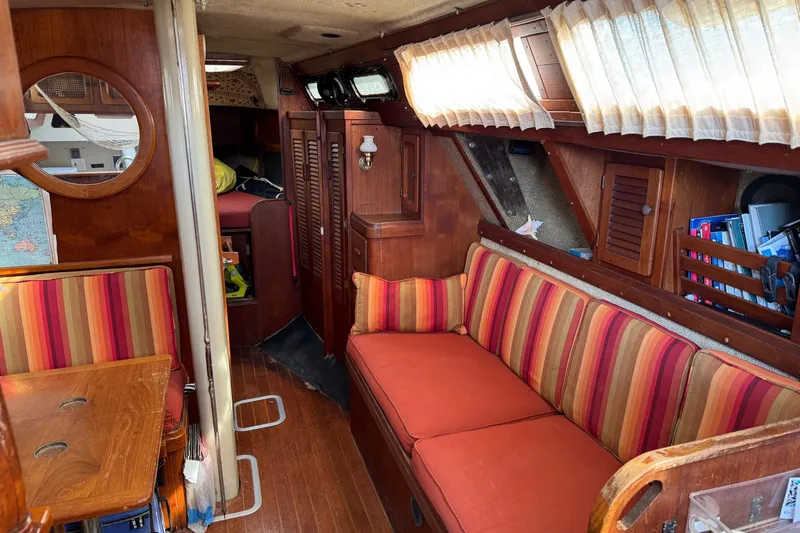 Slide: The Image of Cozy 1981 S2 36 sailboat interior with striped cushions and wooden accents. - 11