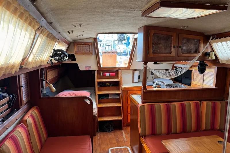 Slide: The Image of Interior of a 1981 S2 36 sailboat with cozy seating and wooden cabinetry. - 15