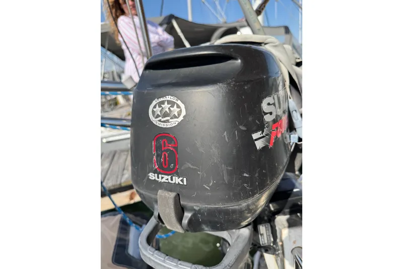 Slide: The Image of Outboard motor with Suzuki branding on a 1981 S2 36 sailboat. - 19