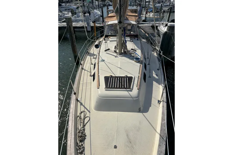 Slide: The Image of 1981 S2 36 sailboat docked at marina, showcasing deck and rigging. - 2