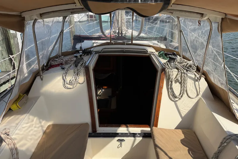 Slide: The Image of 1981 S2 36 sailboat cockpit with ropes and canopy, docked by the water. - 6