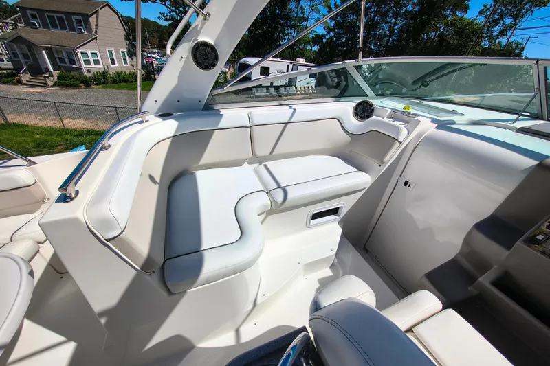 Slide: The Image of 2006 Rinker 300 Express Cruiser interior with white seating and dashboard view. - 11