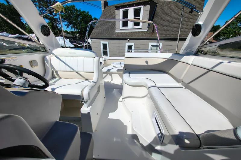 Slide: The Image of 2006 Rinker 300 Express Cruiser interior with white seating and steering wheel. - 13