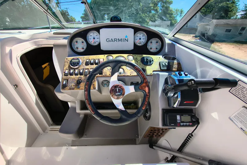 Slide: The Image of 2006 Rinker 300 Express Cruiser helm with Garmin navigation and control panel. - 14