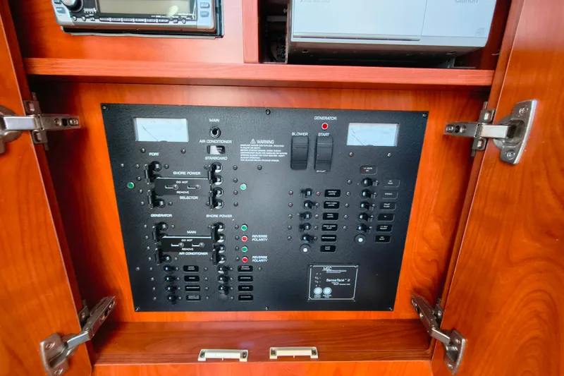 Slide: The Image of Electrical control panel inside a 2006 Rinker 300 Express Cruiser boat cabinet. - 21