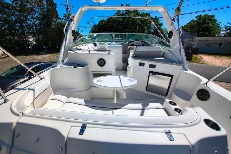 Slide: The Image of 2006 Rinker 300 Express Cruiser interior with seating, table, and dashboard. - 8