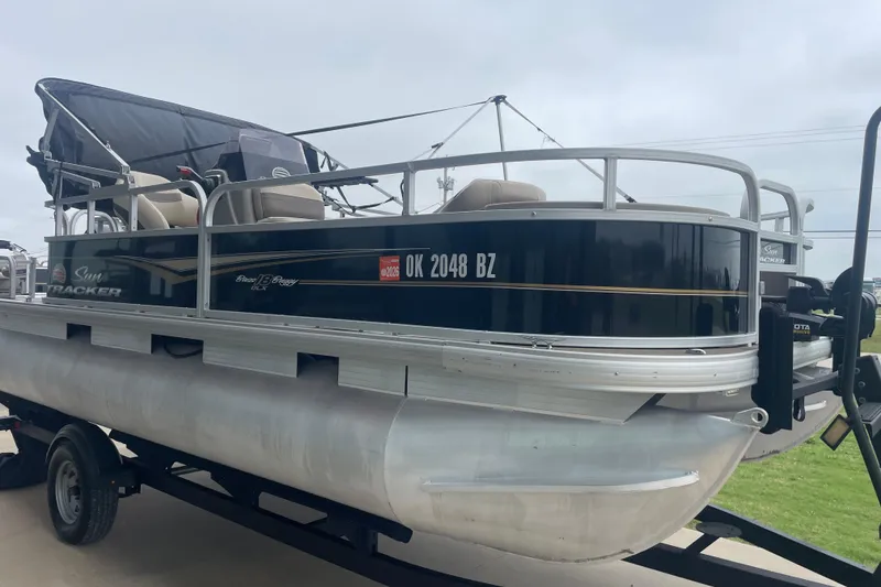 Slide: The Image of 2021 Sun Tracker Bass Buggy 18 DLX pontoon boat on trailer, side view. - 3