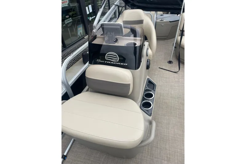 Slide: The Image of 2021 Sun Tracker Bass Buggy 18 DLX boat interior with beige seating and cup holders. - 5