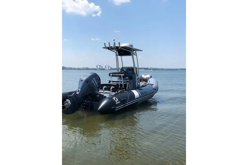 Slide: The Image of 2018 Zodiac Pro Open 650 boat on calm water under clear sky. - 2