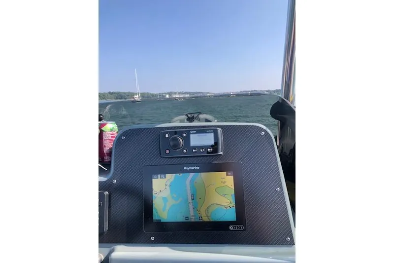 Slide: The Image of Cockpit view of 2018 Zodiac Pro Open 650 with navigation display on water. - 3