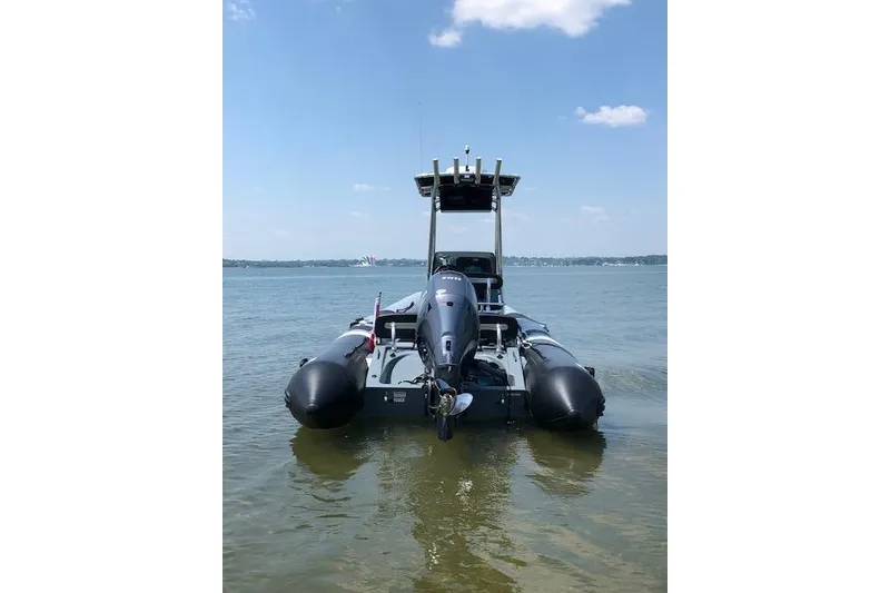 Slide: The Image of 2018 Zodiac Pro Open 650 boat on calm water under a clear sky. - 7