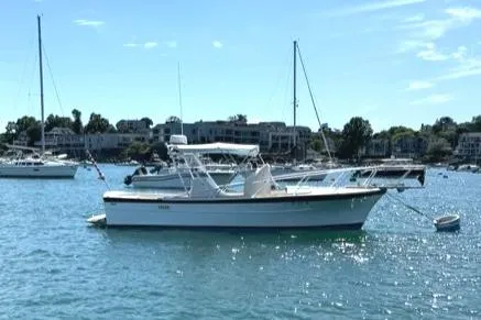 Slide: The Image of 1986 Dusky 26 Custom boat anchored on a sunny day in a marina. - 1