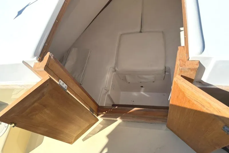 Slide: The Image of Interior cabin view of 1986 Dusky 26 Custom boat with open wooden doors. - 20