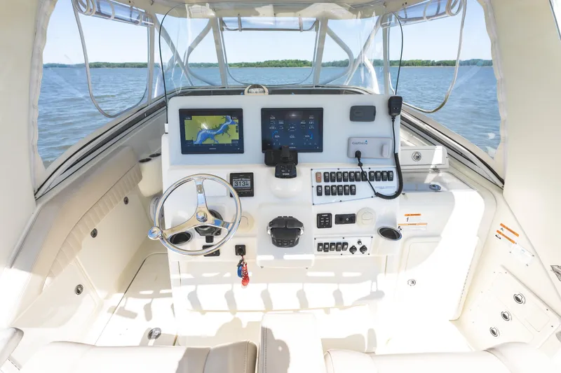 Slide: The Image of Cockpit of 2008 Hydrosport 3500 VX boat with navigation equipment and steering wheel. - 11