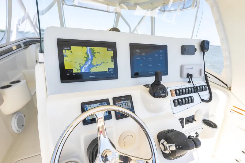Slide: The Image of Control panel of a 2008 Hydrosport 3500 VX boat with navigation screens and controls. - 12