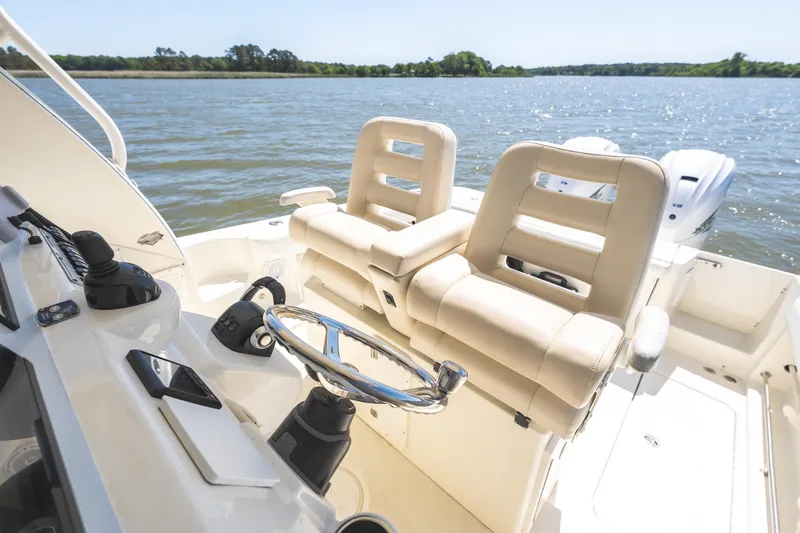 Slide: The Image of 2008 Hydrosport 3500 VX boat interior with dual seats and steering wheel on a sunny day. - 13