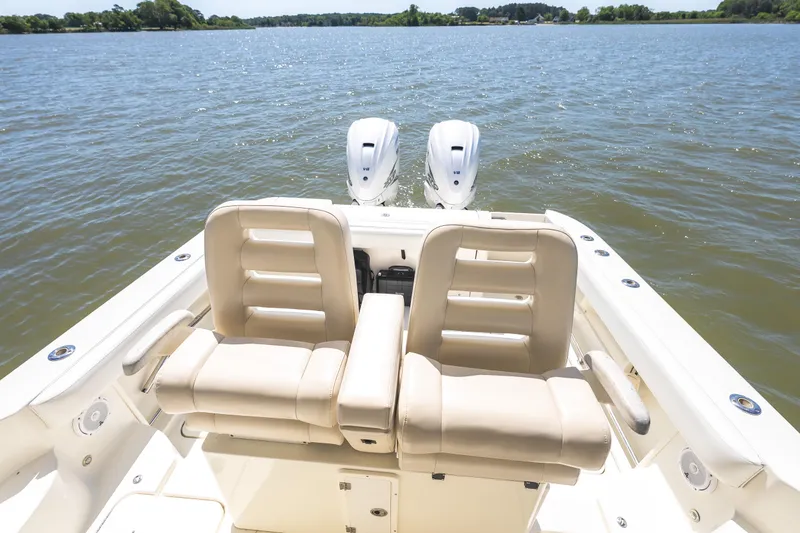 Slide: The Image of 2008 Hydrosport 3500 VX boat with dual engines on a serene lake. - 14