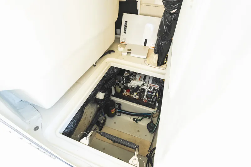Slide: The Image of Engine compartment of a 2008 Hydrosport 3500 VX boat, showcasing mechanical components. - 22