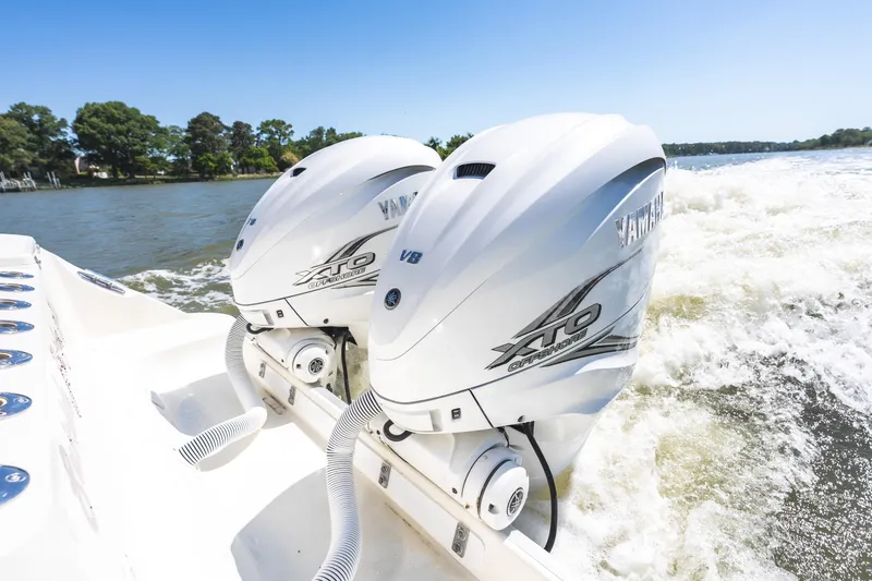Slide: The Image of Twin Yamaha XTO Offshore engines on a 2008 Hydrosport 3500 VX boat cruising on a sunny day. - 23