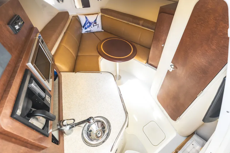 Slide: The Image of Interior of 2008 Hydrosport 3500 vx boat with kitchenette and seating area. - 24