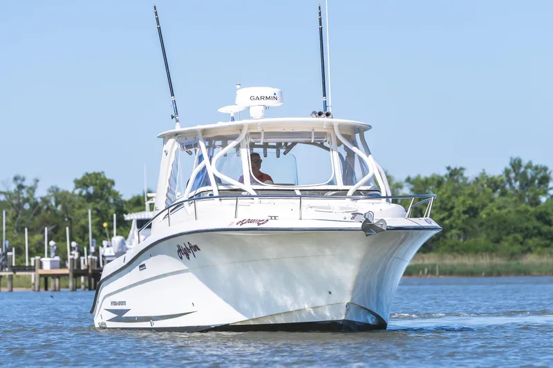 Slide: The Image of 2008 Hydrosport 3500 VX boat cruising on a sunny day near a marina. - 4
