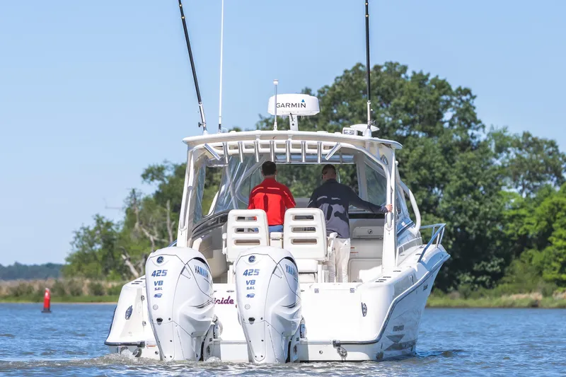 Slide: The Image of 2008 Hydrosport 3500 VX boat cruising on a scenic waterway with twin Yamaha engines. - 6