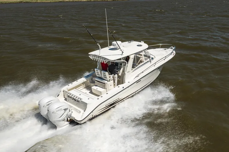 Slide: The Image of 2008 Hydrosport 3500 VX boat cruising on open water with twin Yamaha engines. - 8