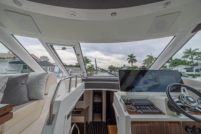 Slide: The Image of 2012 Cruisers Yachts 48 Cantius helm with modern controls and panoramic windows. - 25