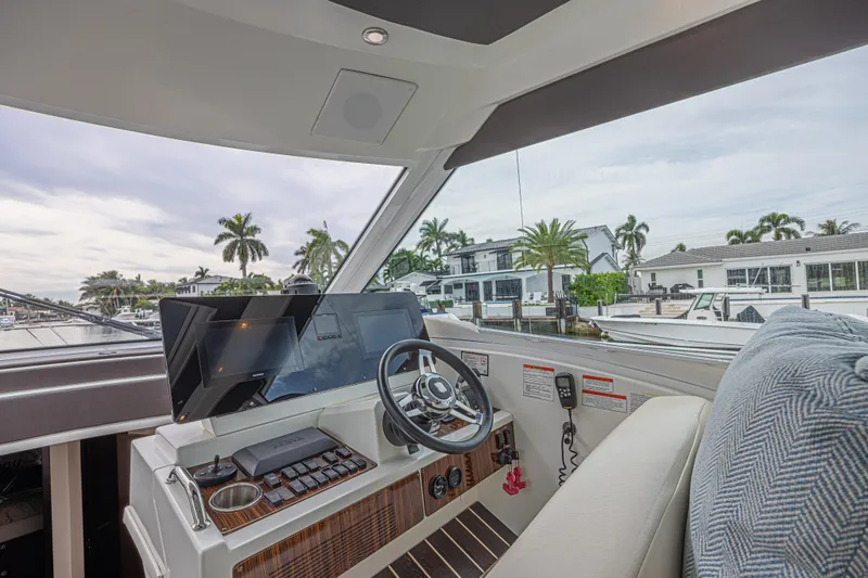 Slide: The Image of Interior view of 2012 Cruisers Yachts 48 Cantius helm with modern controls and waterfront scenery. - 27