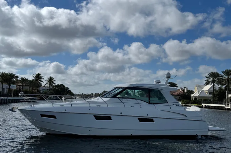 Slide: The Image of 2012 Cruisers Yachts 48 Cantius on water, under a partly cloudy sky. - 7