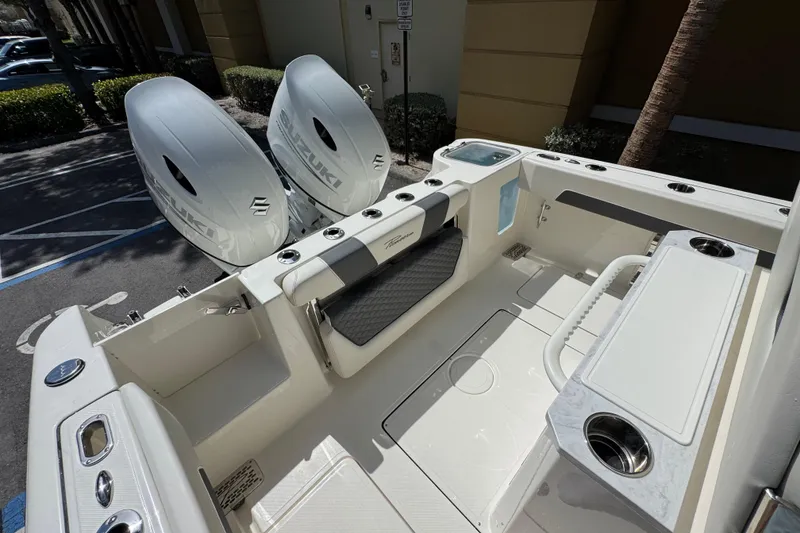 Slide: The Image of 2026 Pioneer 250 Pelagic boat interior with dual Suzuki engines, featuring a spacious deck and seating. - 16