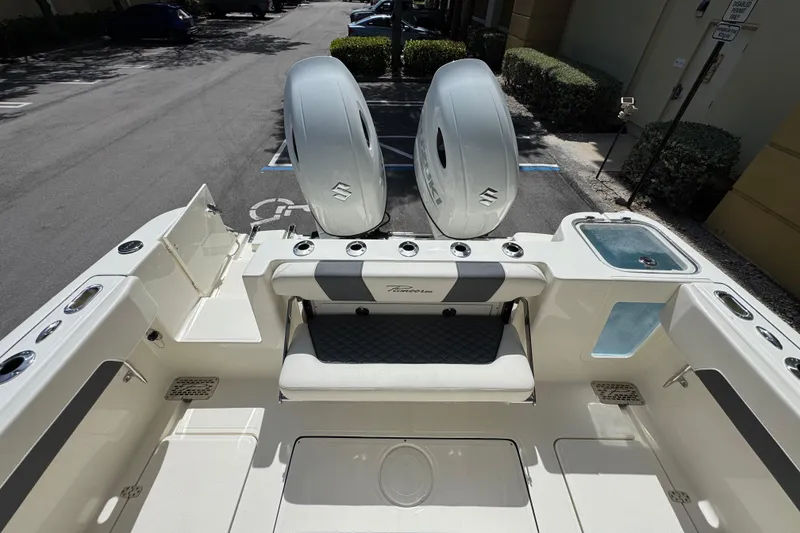 Slide: The Image of 2026 Pioneer 250 Pelagic boat interior with dual engines and seating area. - 19