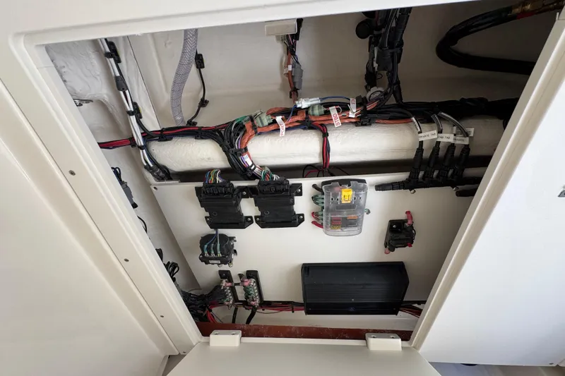 Slide: The Image of Electrical wiring panel inside 2026 Pioneer 250 Pelagic boat, showcasing organized cables and components. - 21
