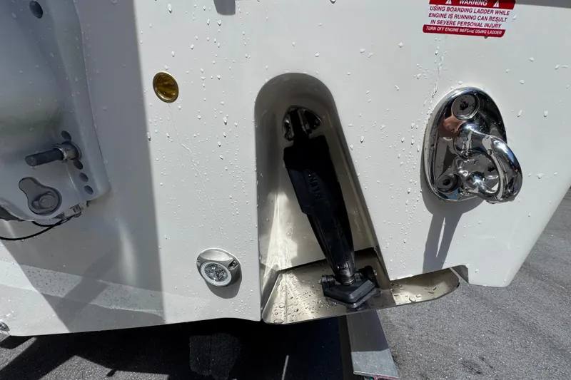 Slide: The Image of Rear view of 2026 Pioneer 250 Pelagic boat with wet surface and hardware details. - 24