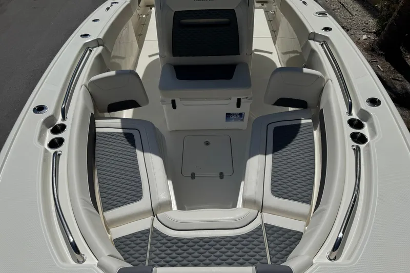 Slide: The Image of 2026 Pioneer 250 Pelagic boat interior with cushioned seating and storage compartments. - 4