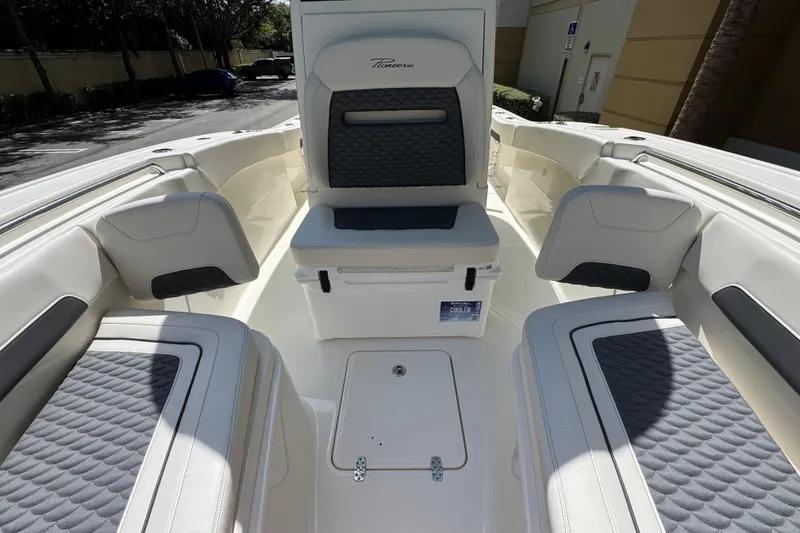 Slide: The Image of 2026 Pioneer 250 Pelagic boat interior with cushioned seating and storage compartments. - 5