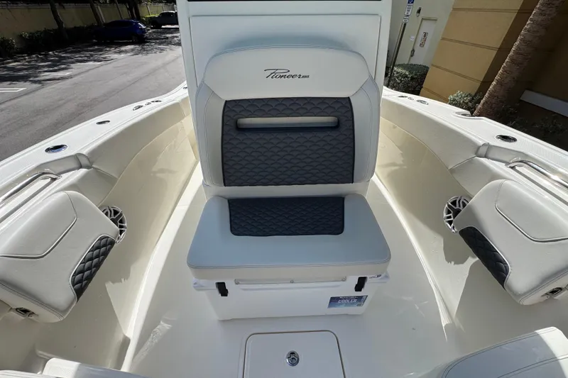 Slide: The Image of 2026 Pioneer 250 Pelagic boat interior with cushioned seating and storage. - 6
