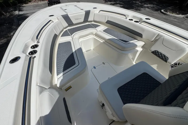 Slide: The Image of 2026 Pioneer 250 Pelagic boat interior with cushioned seating and sleek design. - 9