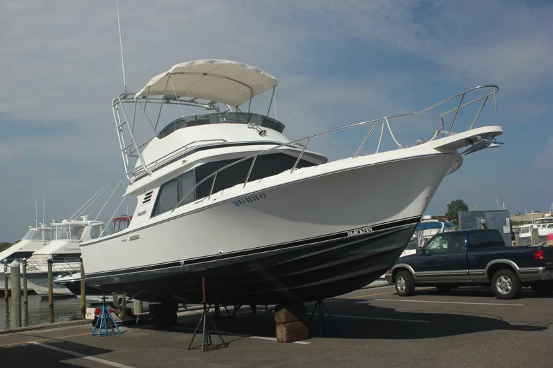 The Image of 1995 Blackfin 29 Flybridge boat on dry dock, marina background. - 1