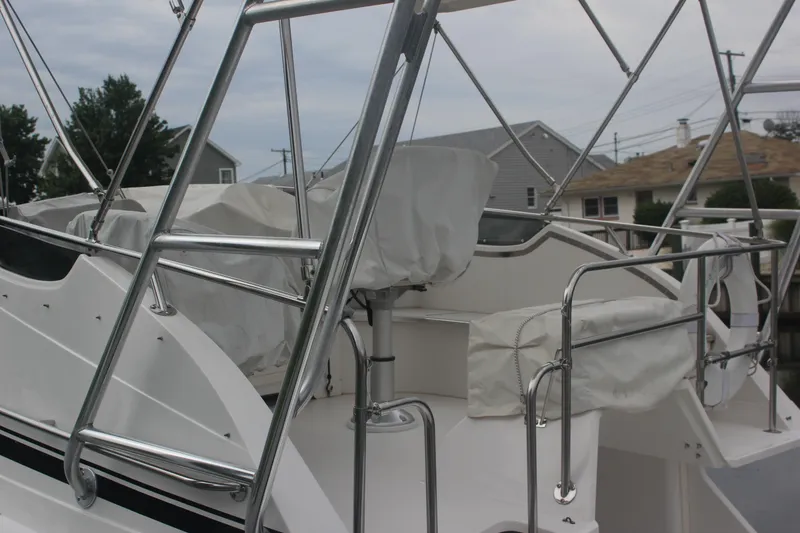 Slide: The Image of 1995 Blackfin 29 Flybridge boat with covered seating and stainless steel railings. - 6