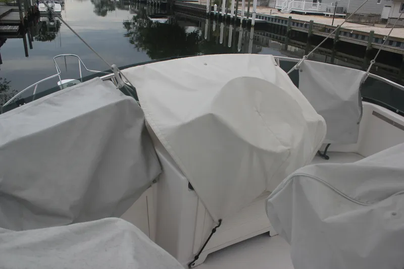 Slide: The Image of Covered deck of a 1995 Blackfin 29 Flybridge boat docked by calm waters. - 7