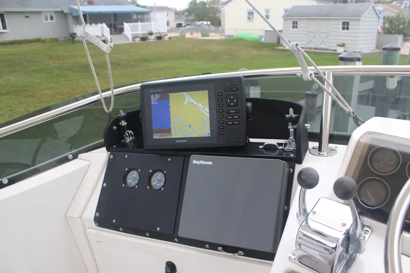 Slide: The Image of 1995 Blackfin 29 Flybridge helm with Garmin navigation system and Raytheon equipment. - 9